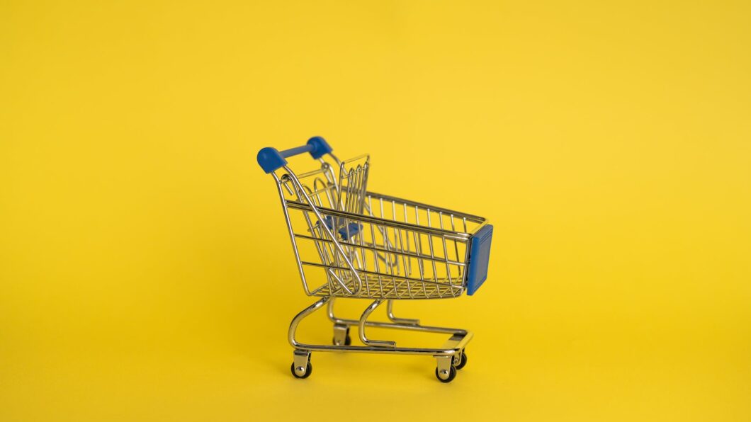 empty shopping cart on yellow background